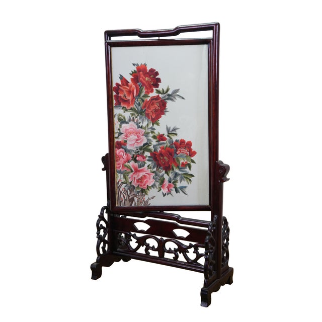 Vintage Chinese silk embroidered fire screen featuring pink and red peonies and a reticulated rosewood stand. Dimensions:...