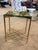 This striking accent table features a vibrant green resin top embedded with natural stone fragments, creating a unique...
