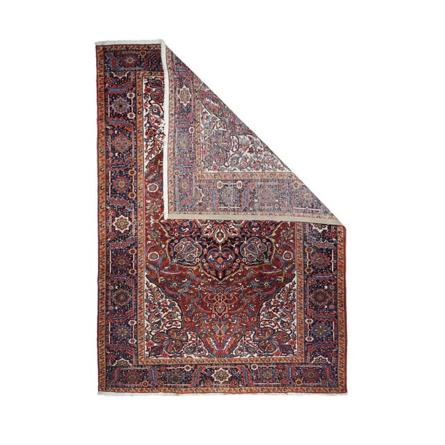 A semi-curvilinear Heriz style, developed first in the later 1940's, this prime example shows a shaped red field with a...