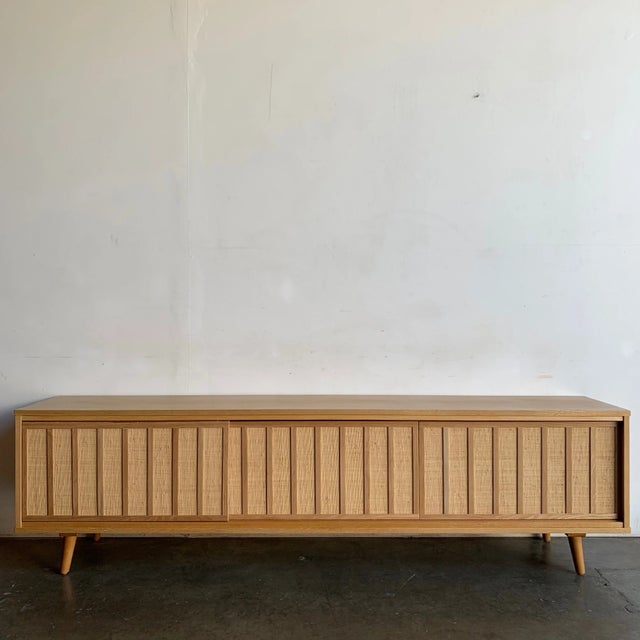 W86.5 D16.25 H23.5 Using a combination of solid wood and white oak veneer. The doors feature wooden accents with a cane...
