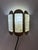 A striking lighting object from Denmark: This golden wall lamp from the Danish manufacturer Vitrika captivates with its...