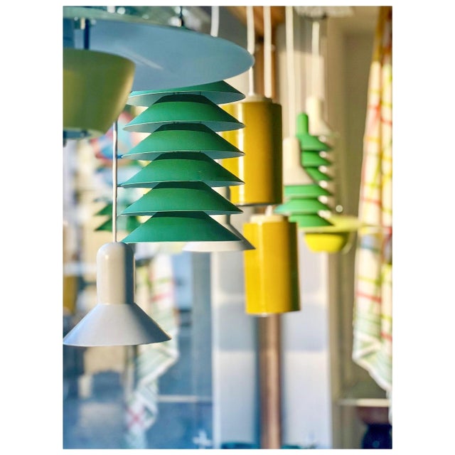 This pendant lamp is cleverly designed with a reflective multi-shade system that distributes the light across six discs....