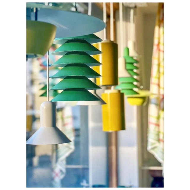 This pendant lamp is cleverly designed with a reflective multi-shade system that distributes the light across six discs....