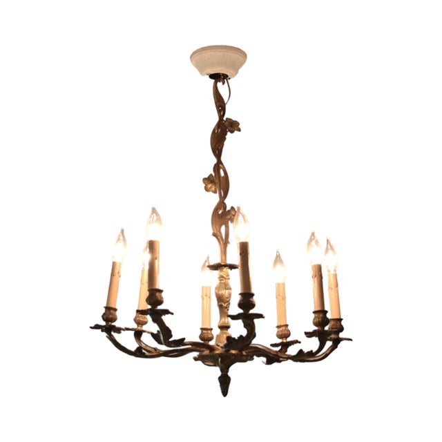 An antique, 19th-century, French brass 8-arm, wired and working chandelier with botanical leaf and flower designs. The...
