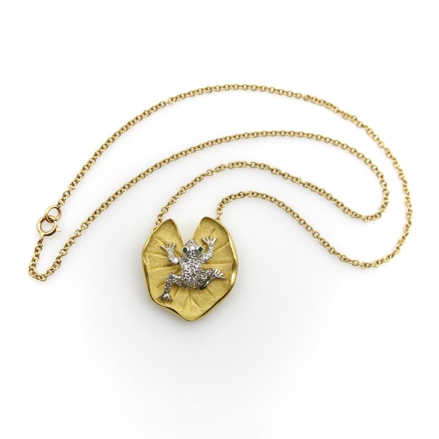 This McTeigue & Co. necklace features a diamond encrusted platinum frog sitting on an 18k gold lily pad, connected to a...