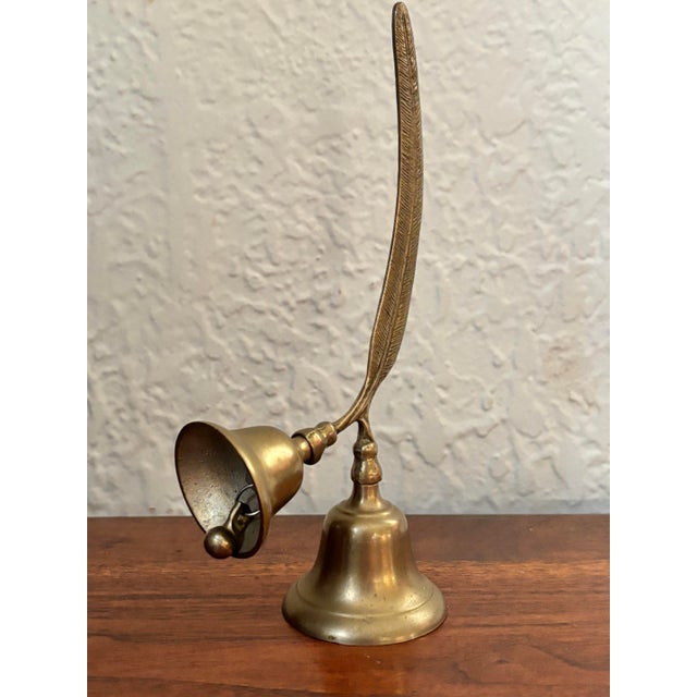 Vintage solid brass double bell with a feather handle. The bells produce bright chimes in two tones. Please see condition...