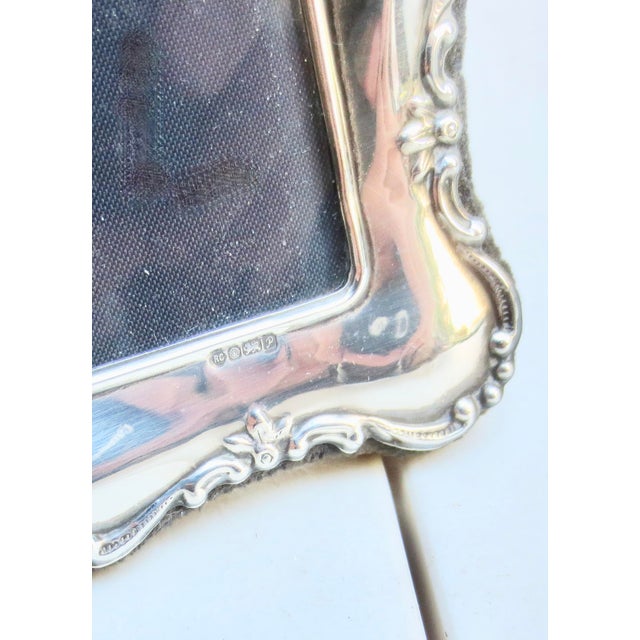 Sterling Silver frame from England with velvet back and brace. Faced with glass, stands vertical. The measurements are...