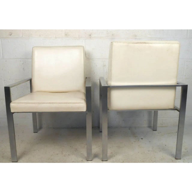 This set of four dining chairs features sturdy aluminum frames, vintage leather upholstery, and comfortable design. Unique...