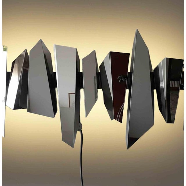 Impressive wall lamp/sculpture model "Leda" realized in metal by Mario Torregiani in 1990s. Very good condition. This...