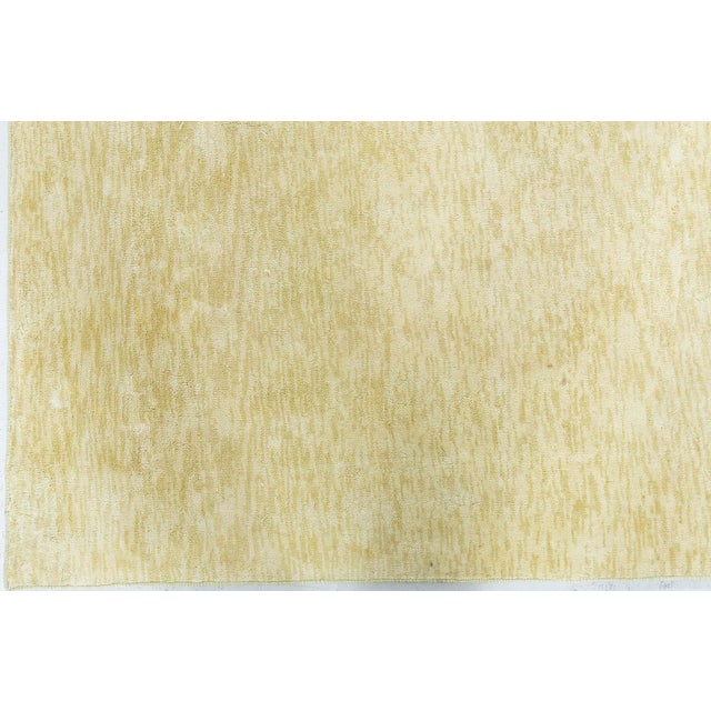 A celebration of subtle opulence and refined minimalism, this modern solid yellow silk runner exudes timeless elegance....