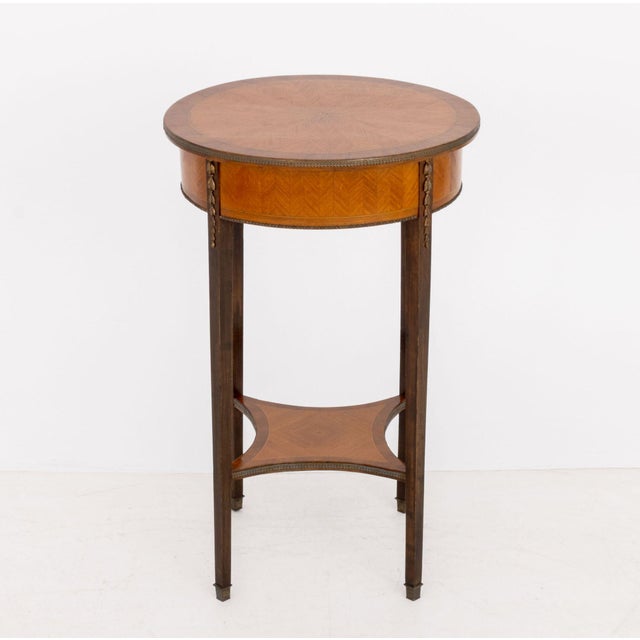 Louis XVI Style Gilt Metal Mounted Parquetry Occasional Table, the circular top above an undertier. 28.25" H x 17.75"...