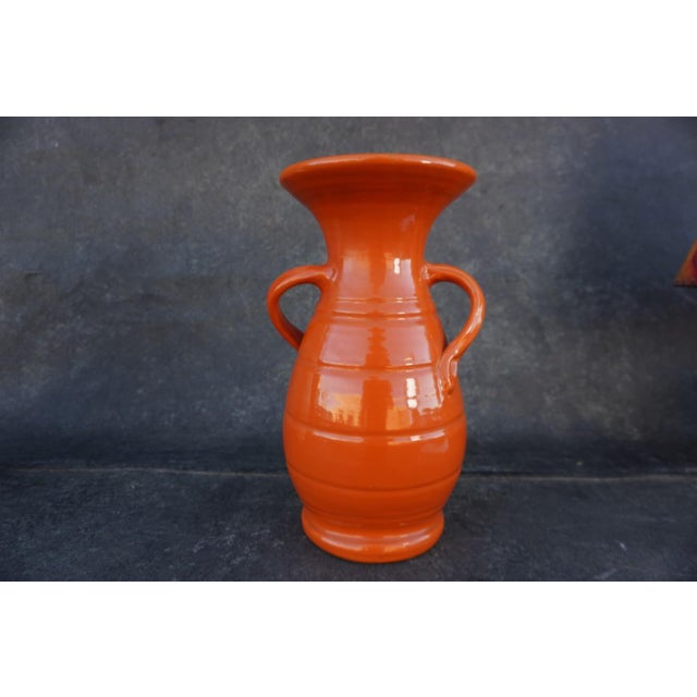 A rare Bauer Pottery “Carlton” vase in vibrant orange glaze, produced in Los Angeles in the 1930s. The sculptural form...