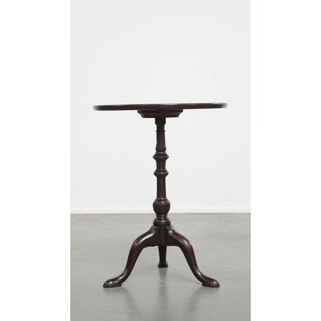 This English antique side table / wine table with single piece top from the early 19th century. This attractive round...