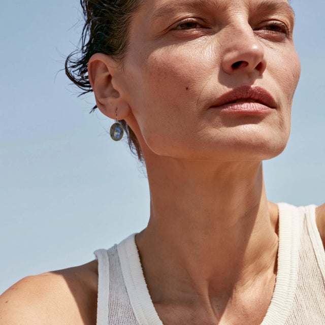 A quiet glow with a hidden spark — these labradorite earrings reveal flashes of blue fire as they move, anchored by a...