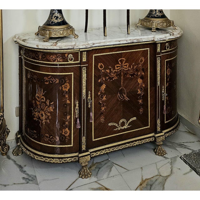 Bring timeless European elegance into your home with this grand French Louis XVI-inspired commode, featuring an impressive...