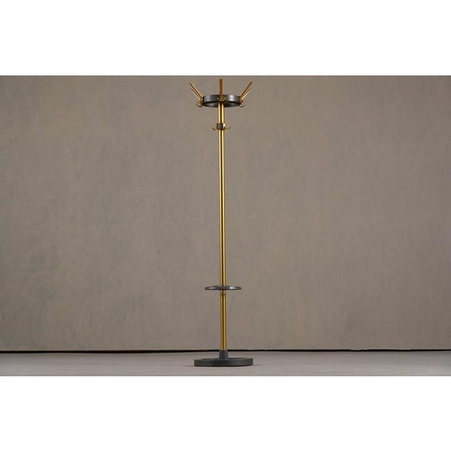 A striking and rare 1950s coat stand designed by renowned French modernist Jacques Adnet. This sculptural piece reflects...