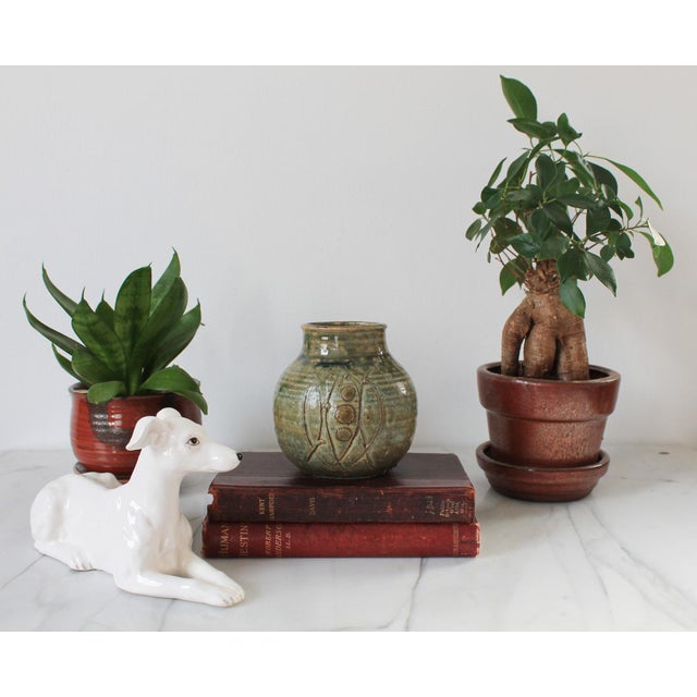 Vintage textured studio art pottery vase in earth tones. Signed by artist on bottom. Minor age wear. No chips or cracks.