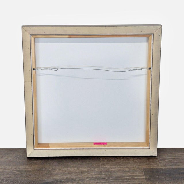 This is a modern abstract painting featuring bold black circles on a white background. The artwork comes in a sleek frame,...