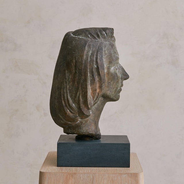 A cast bronze bust of a woman, signed by the artist and bearing the foundry mark Cire M. Pastori Perdue. Dating to the...