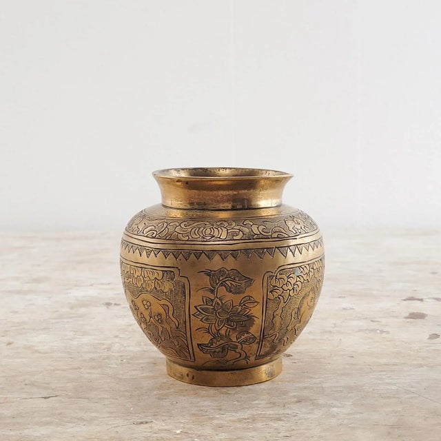 A Chinese bronze vase decorated with horses.