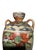 A quietly sculptural antique Japanese art pottery vase with a balanced double-handled silhouette and hand-painted floral...