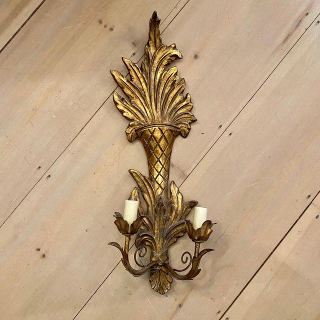 Pair of French carved giltwood wall sconces featuring elongated diamond-carved urn forms issuing dramatic carved foliate...