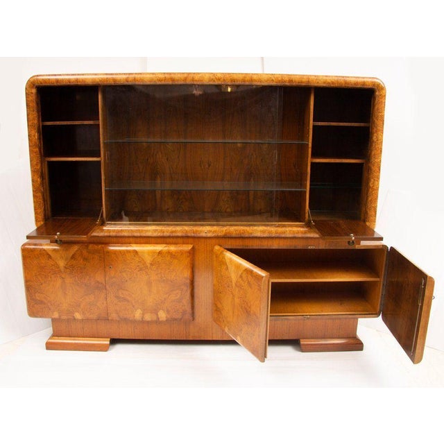 H: 172cm w: 233cm d: 43cm a british art deco high board with cupboards to base and a glass-fronted top display cabinet...
