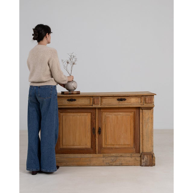 Here is a sideboard, its natural bleached oak, 2 doors open showing shelf the first thing to catch the eye. The piece...