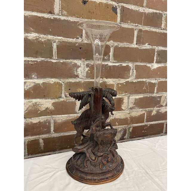 Black Forest carved base with two goats and floral design with carved palm leaves. The glass vase is designed with...