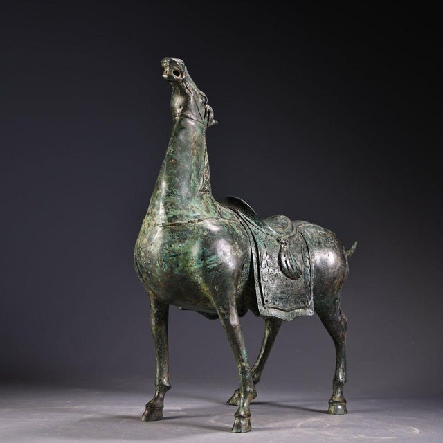 This stunning piece is masterfully crafted from heavy solid bronze with a rich, mottled green and brown patina. It depicts...