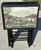 Vintage 1960s/1970s set of four folding TV snack trays with a storage stand. Black with a classic English fox hunting...