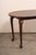 A British Colonial oval rosewood occasional table from the early 20th century. This antique Anglo-Indian table has an...