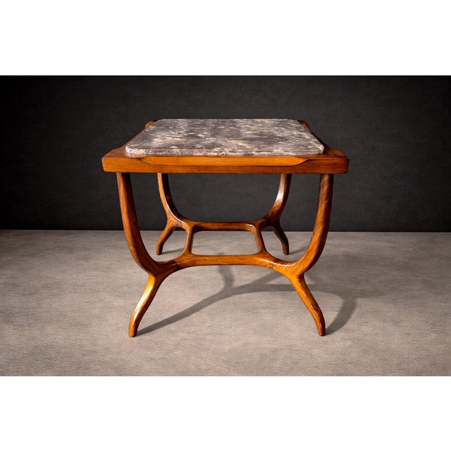 This sculptural side table reflects the organic formal language that defined Brazilian modernism in the mid-20th century....