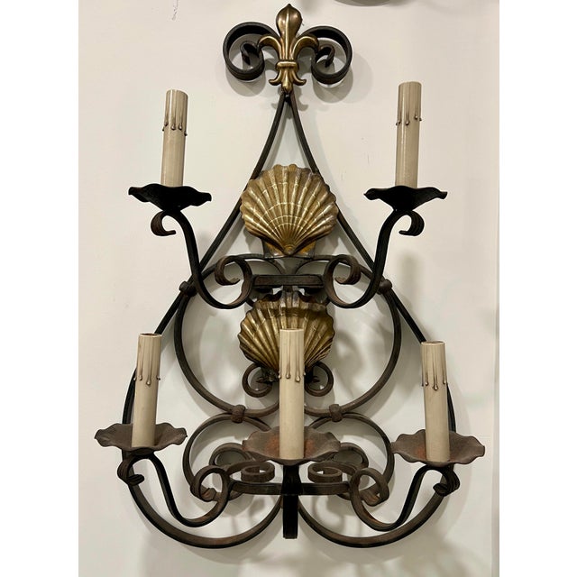 Magnificent pair of vintage iron sconces with shell accents. These are wired and ready to install if preferred.