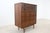 Crafted by Stanley Furniture, this striking mid-century modern highboy dresser showcases beautifully grained walnut and a...