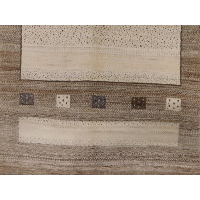 Vintage hand knotted nomadic Persian rug by Zollanvari. Finely woven of natural undyed hand spun wool pile on cotton...