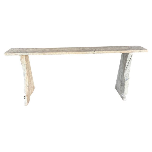 Impressive console table made from a hundred year old reclaimed teak wood. Two solid unique sculptural legs support the...
