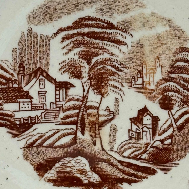 This antique brown transferware plate measures 5.75” across and has the wonderfully timeworn character that makes early...