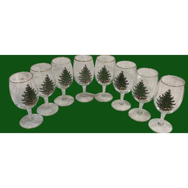 A set of 8 Spode wine glasses. Adorn with a Christmas tree and gold rim.