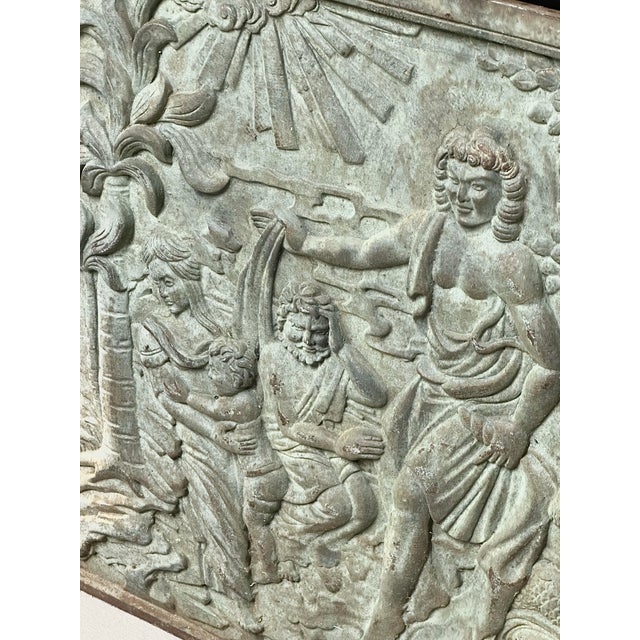 Substantial antique cast iron fireback featuring an elaborate raised figural scene surrounded by a molded border. The...