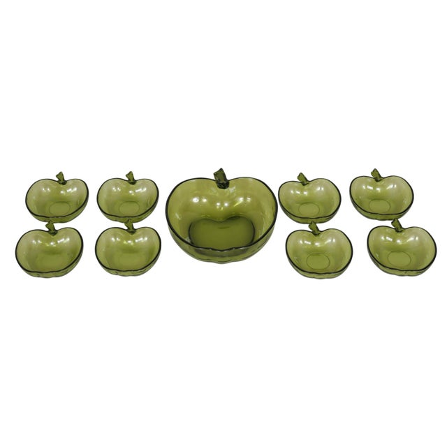 A set of nine 1960’s green glass bowls made by Hazel-Atlas Glass. Eight small bowls and one large bowl are molded into the...