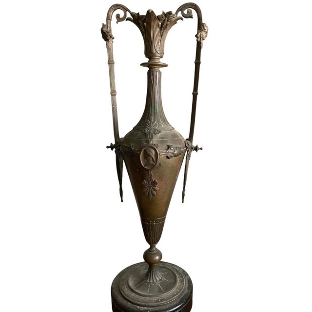 Description: Striking neoclassical urn featuring an elegant amphora form with high scrolled handles, fluted neck, and...