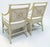 A distinctive pair of vintage rattan armchairs featuring sculptural target-style backs, intricately wrapped frame details,...