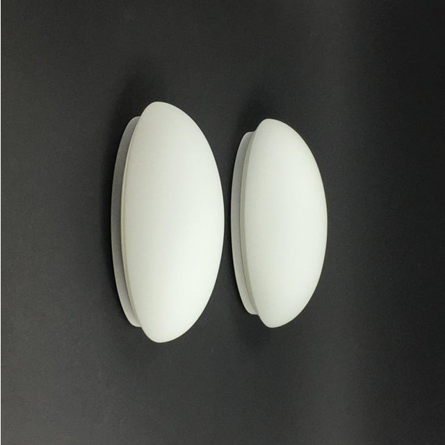 Pair of minimalist opaline glass wall lamps/sconces from Limburg, Germany's leading glasswork, renowned for its premium...