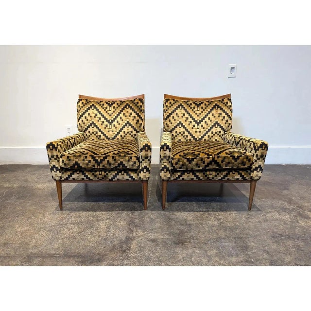 Pair of rare Paul McCobb for Directional Furniture lounge chairs circa 1950s. Curved top frame and tapered legs in walnut...