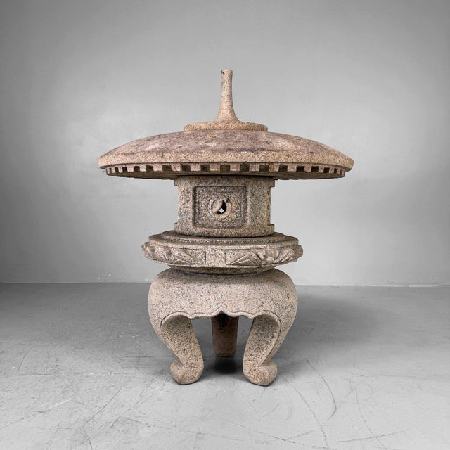 A Japanese garden lantern with a broad round roof, gracefully curved legs and a beautiful natural patina. Dimensions:...