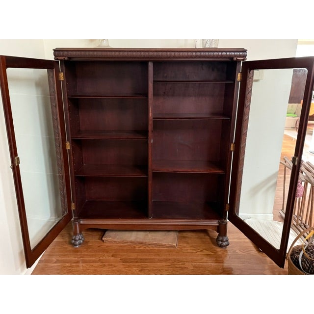 Large Victorian Double Door Bookcase crafted from quartersawn oak, featuring carved columns, claw feet and original glazed...