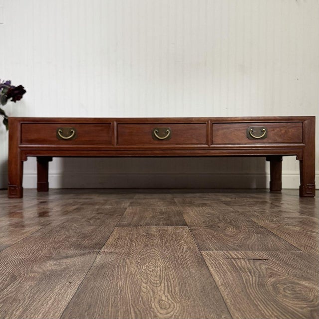 Lovely coffee table with a modern mid-century Asian style. Features a low profile, stunning grain patterning, and three...