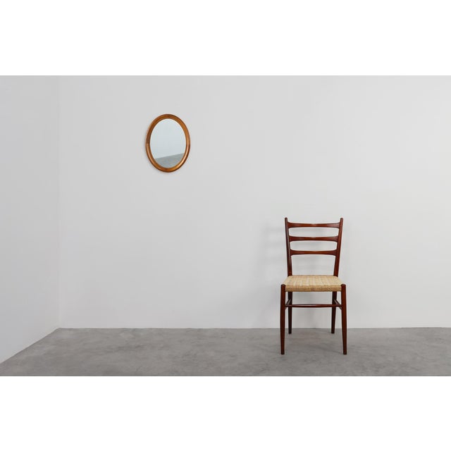A warm and elegant mid‑century oval mirror from Belgium, crafted in the 1950s from beautifully carved oak. This piece...