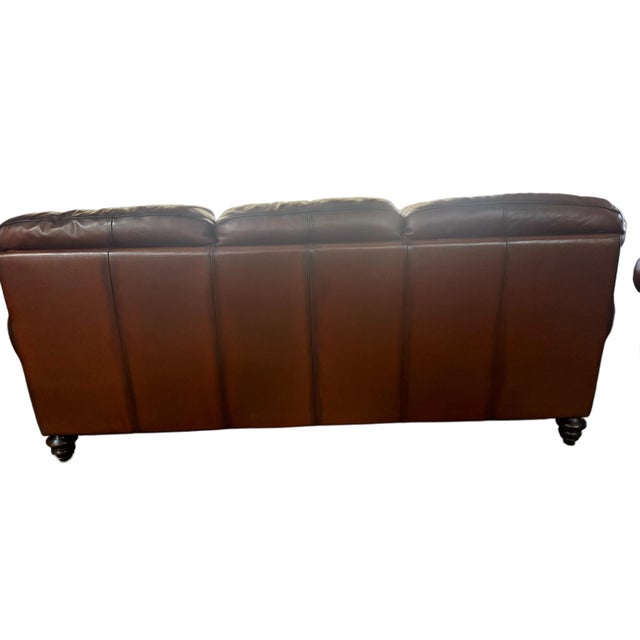 Crafted in Italy in June 2004, this Natuzzi Maturità Model 1855 sofa is upholstered in rich cognac top grain protected...